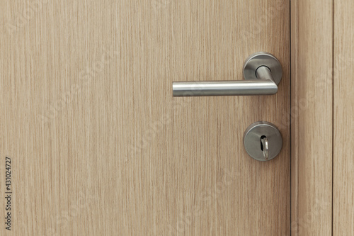 wooden room door with metal handle