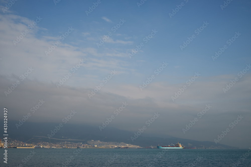 Image of merchant ships in the sea at anchorage.