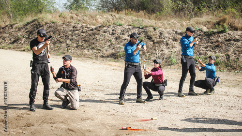 Group of students on training for handling and shooting in shooting range