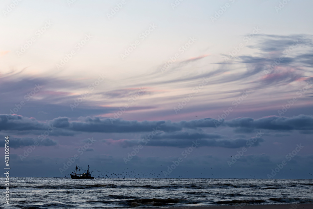 fishing ship in sea and sunset sky