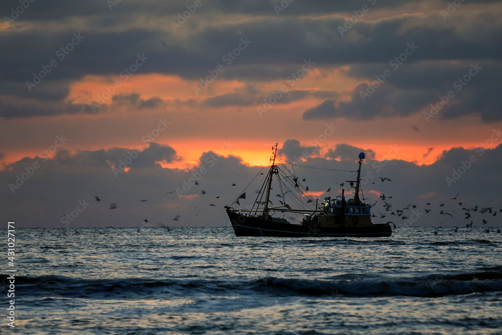 fishing boat on North sea at sunset