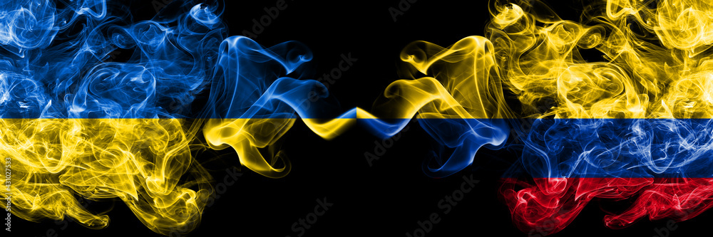 Fototapeta premium Ukraine, Ukrainian vs Colombia, Colombian smoky mystic flags placed side by side. Thick colored silky abstract smokes flags.