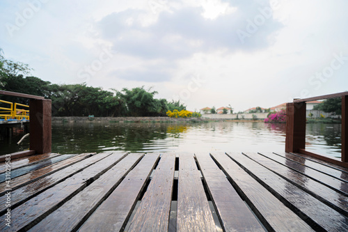 Lake pier at evening with hills on background.