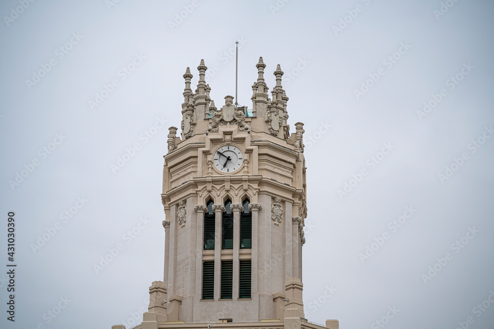 Detail photograph of the tower and clock of the Madrid Post Office Palace, seat of the Madrid City Council