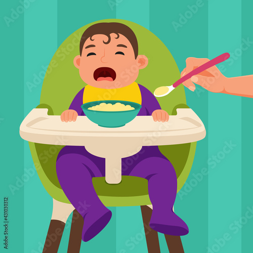 The baby sits in the feeding chair and refuses to eat when he is being fed.