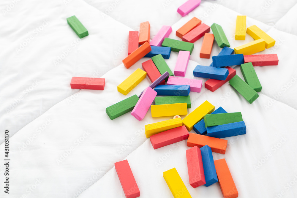 Colored wooden toy on a white background. Toy blocks, multicolor wooden bricks on white background. Colored wooden toy on a white background. Toy blocks, multicolor wooden bricks on white background.