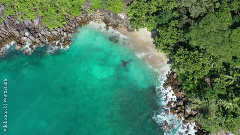 Drone field of view of waves crashing into secret cove, sea and forest Mahe, Seychelles. Drone field of view of waves crashing into secret cove, sea and forest Mahe, Seychelles.