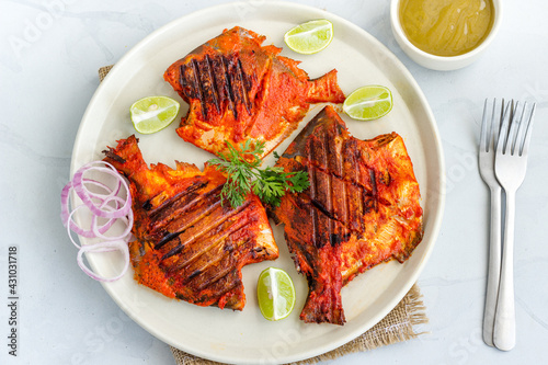 Tandoori Fish on a Plate with Condiment and Lemon, Directly Above Photo