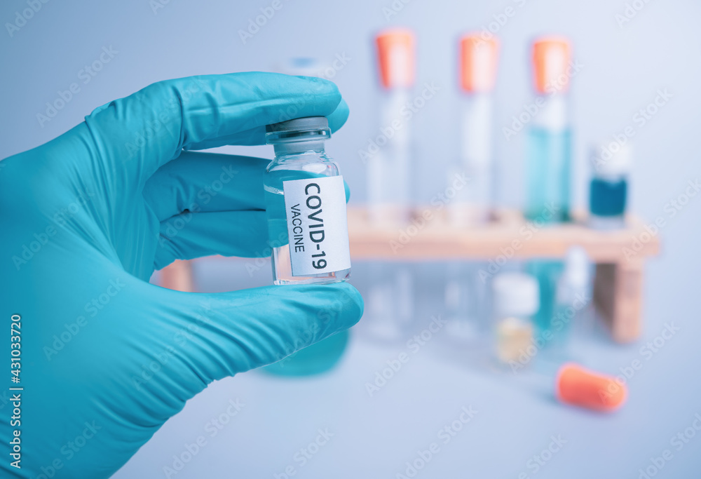 Medical doctor or laborant holding tube with nCoV Coronavirus vaccine for 2019-nCoV COVID virus Medical doctor or laborant holding tube with nCoV Coronavirus vaccine for 2019-nCoV COVID virus