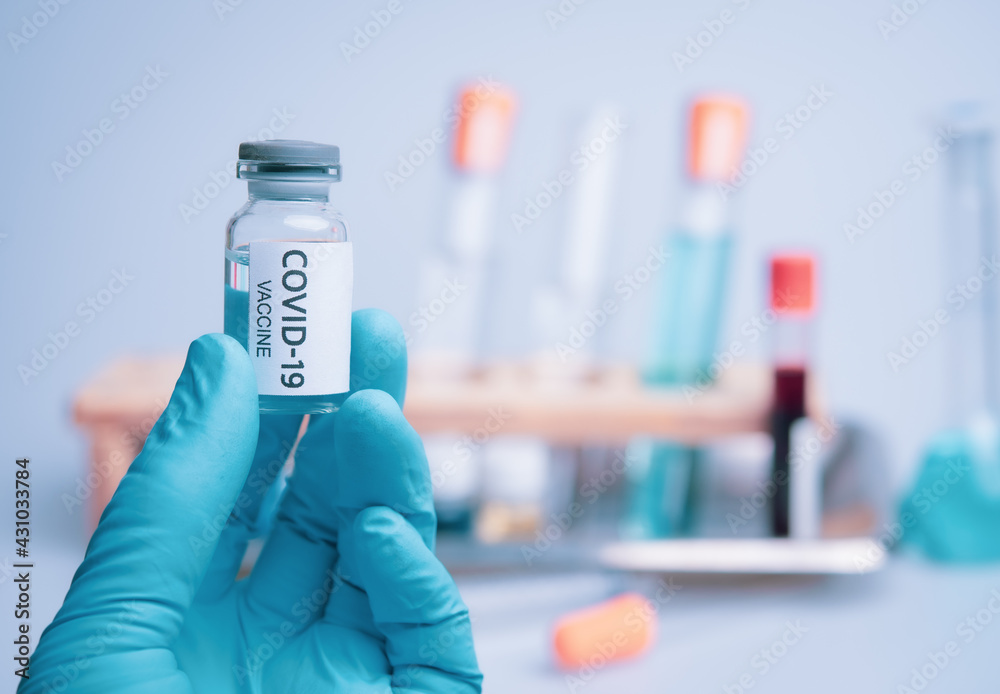 Medical doctor or laborant holding tube with nCoV Coronavirus vaccine for 2019-nCoV COVID virus Medical doctor or laborant holding tube with nCoV Coronavirus vaccine for 2019-nCoV COVID virus