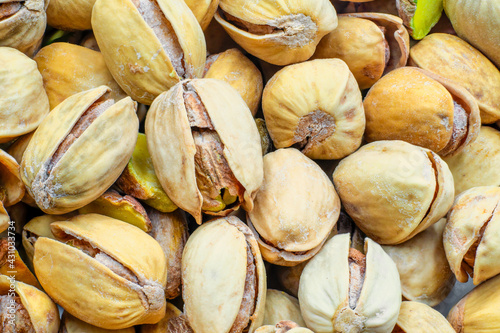 Raw salted pistachios nuts, top down view. Macro shot, perfect for vegan diet and healthy eating.
