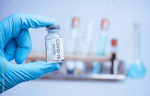 Fototapeta Naklejka Na Ścianę i Meble -  Medical doctor or laborant holding tube with nCoV Coronavirus vaccine for 2019-nCoV COVID virus
