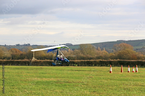 Valokuva Ultralight airplane landing on a grass strip