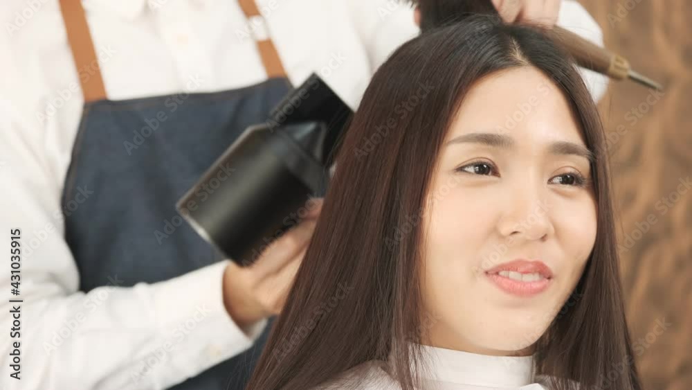 Beautiful asian woman sitting by hairdresser getting her hair done. Beautiful asian woman sitting by hairdresser getting her hair done.