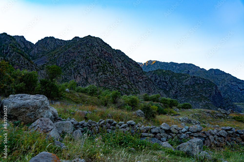 view of rocks and mountains and grass