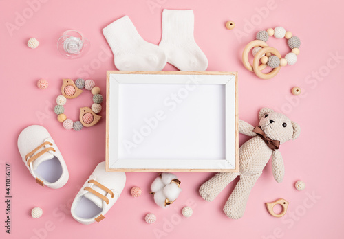 Mockup of empty frame with eco friendly baby accessories photo