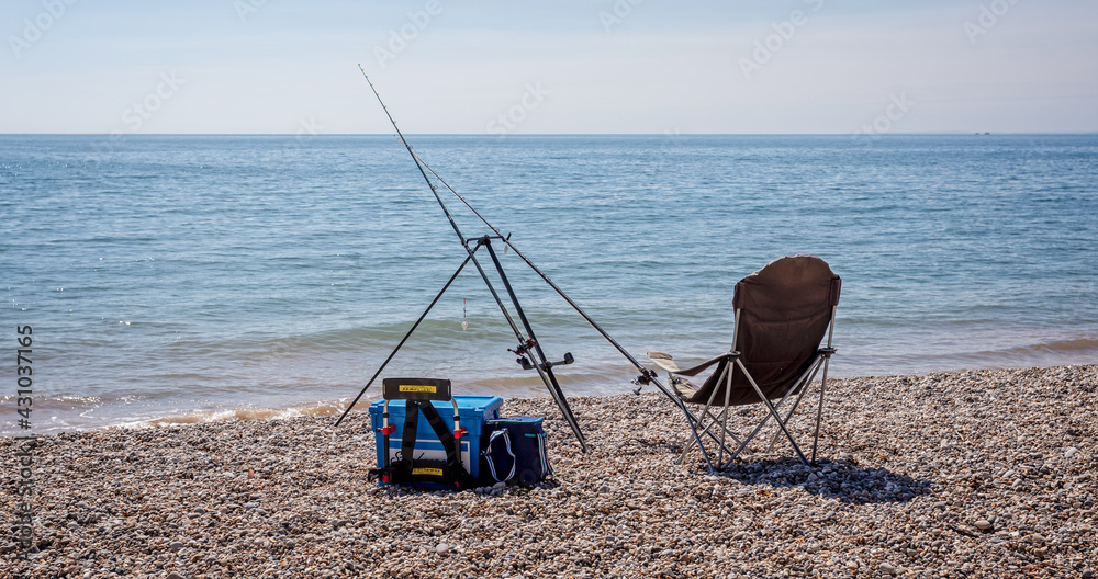 Pair of fishing rods set up on beach for sea fishing Pair of fishing rods set up on beach for sea fishing