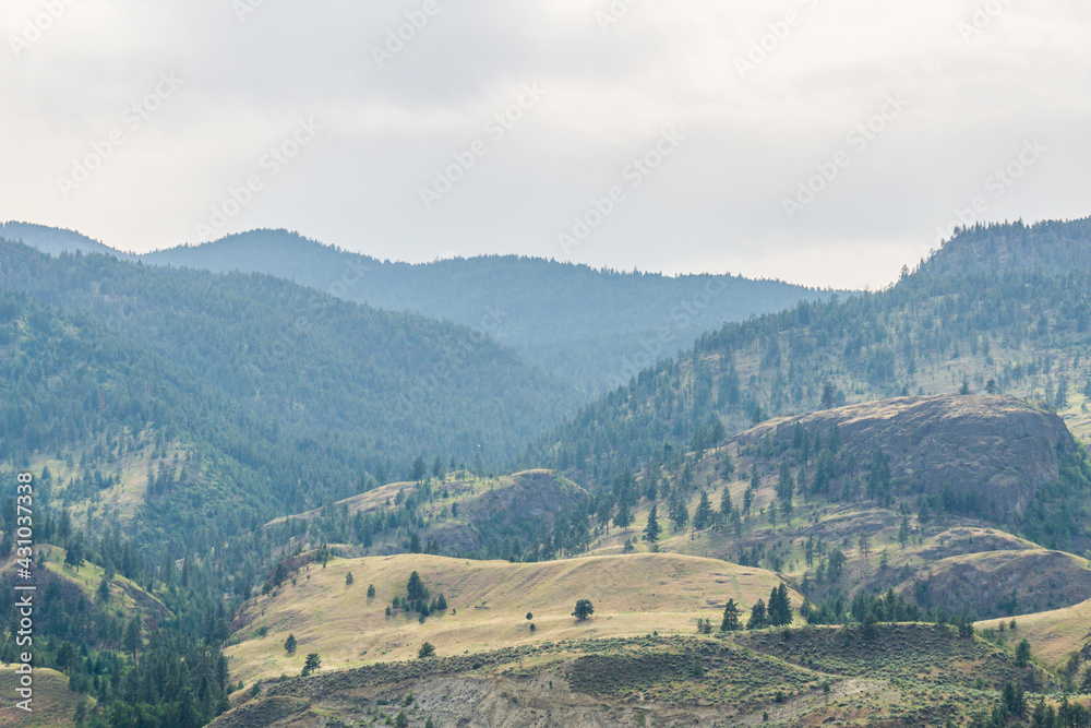 Fototapeta premium mountains in Okanagan valley and cloudy sky.