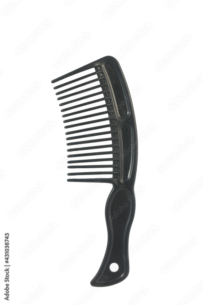 Black plastic comb on white background, close up image Black plastic comb on white background, close up image