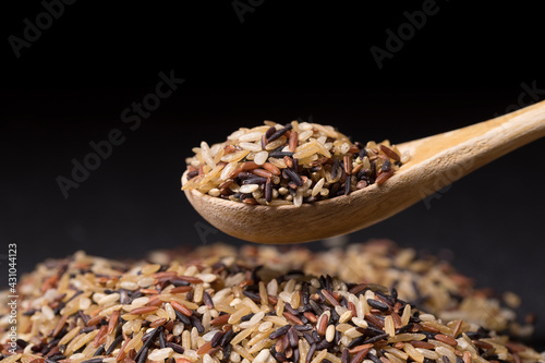 Spoonfull of raw wild rice. photo