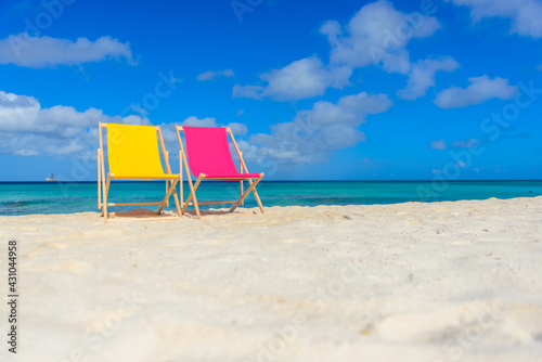 Fototapeta Naklejka Na Ścianę i Meble -  Colorful beach lounge chairs at the beach