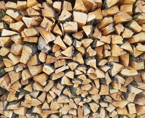 Background of chopped wood lying on top of each other. Pile of chipped wood close-up