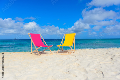Fototapeta Naklejka Na Ścianę i Meble -  Colorful beach lounge chairs at the beach