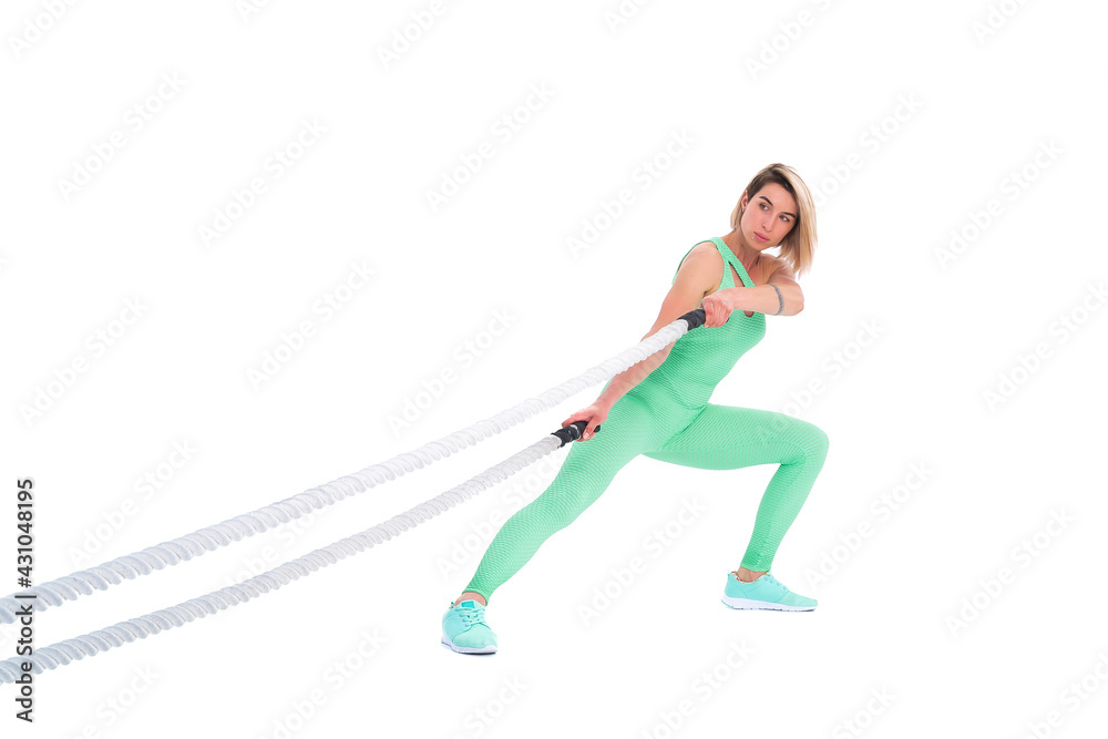 Naklejka premium Woman doing exercises with battle rope.