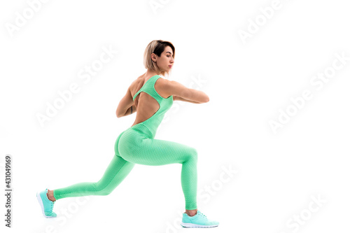 full body portrait of young sporty woman stretching before exerc