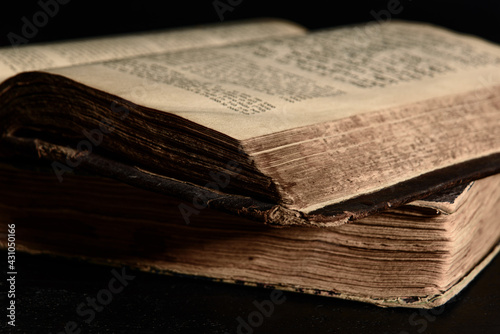 Jewish Bible. Old worn Jewish books. Opened scripture pages. Selective focus. Closeup. photo