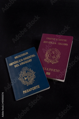 Italian and Uruguayan passport in background black