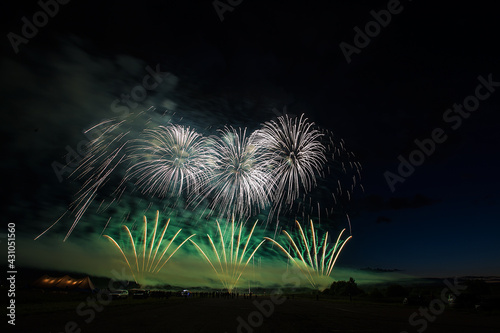 a crowd of people came to the festival, a festival of fireworks, explosions of pyrotechnic charges, volleys of salutes against the backdrop of happy people rejoicing in the beautiful spectacle, multic photo