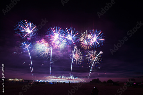 a crowd of people came to the festival  a festival of fireworks  explosions of pyrotechnic charges  volleys of salutes against the backdrop of happy people rejoicing in the beautiful spectacle  multic