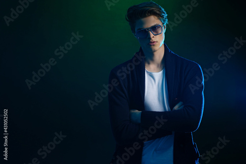 Cool stylish man in black jacket and sunglasses. High Fashion ma © zamuruev