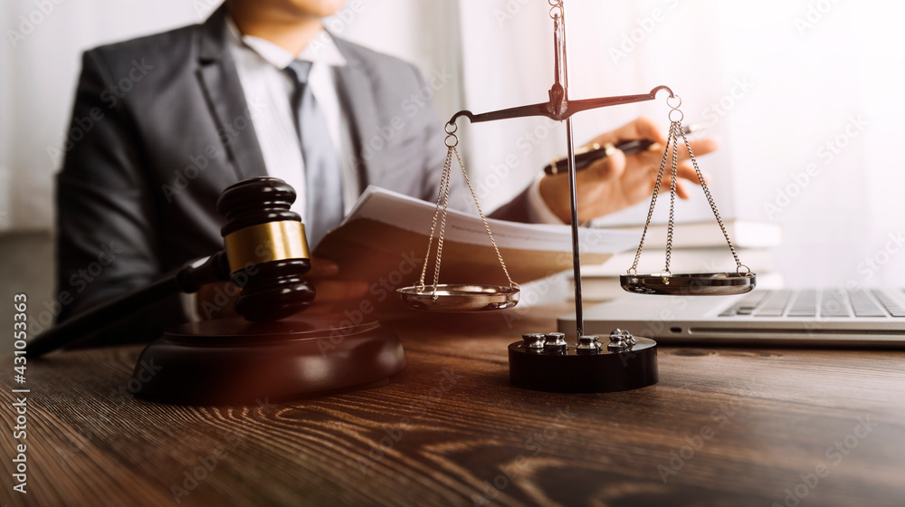 Business and lawyers discussing contract papers with brass scale on desk in office. Law, legal services, advice, justice and law concept picture with film grain effect Business and lawyers discussing contract papers with brass scale on desk in office. Law, legal services, advice, justice and law concept picture with film grain effect