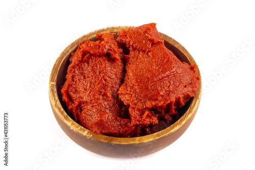 Tomatoes paste witTomatoes paste with ripe tomatoes isolated on white background. Tomatoes with a dish of tomato paste garnished. Fresh homemade tomato sauce.