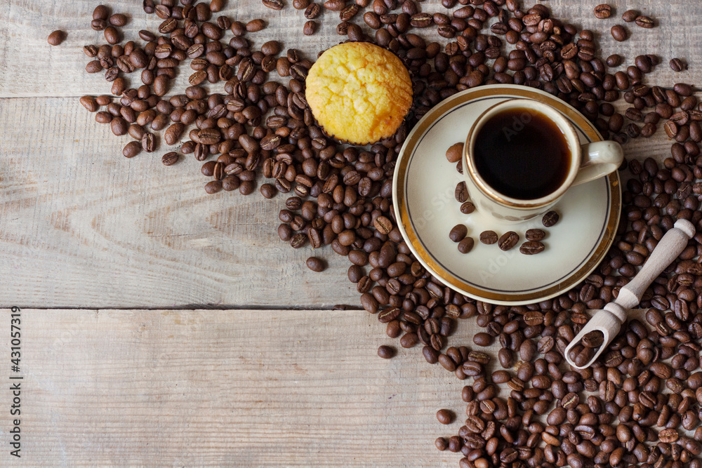 A cup of coffee. Cup of coffee on a wooden background. Coffee beans. View from above. Copy space A cup of coffee. Cup of coffee on a wooden background. Coffee beans. View from above. Copy space