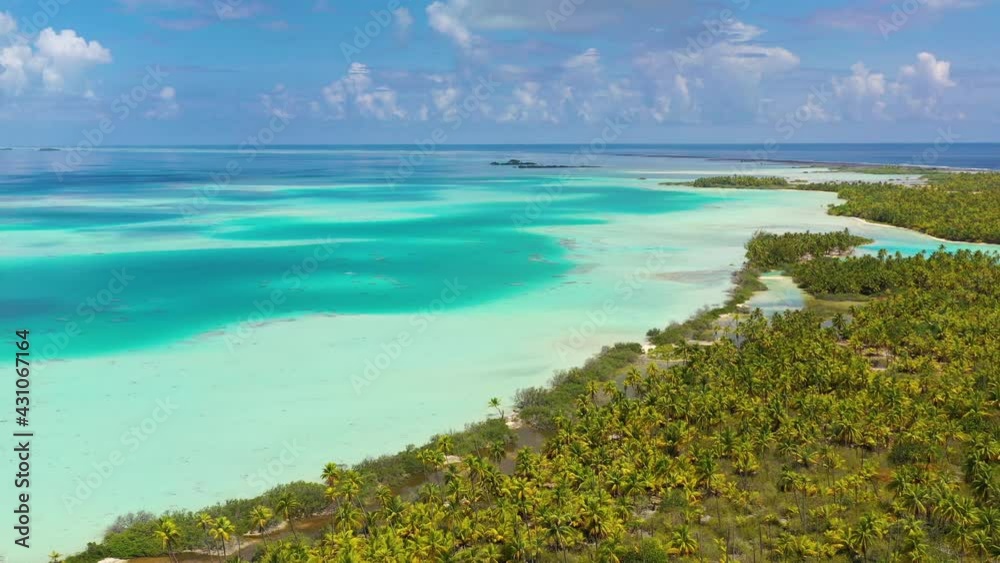 Drone video of French Polynesia Tahiti Rangiroa Fakarava atoll and Blue Lagoon and motu island with perfect beach and coral reef. Aerial footage of Tropical travel paradise in Tuamotus Islands