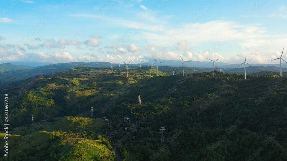 Windm ills and a wind farm on the hillsides. Philippines, Luzon. Wind turbines in the mountains.