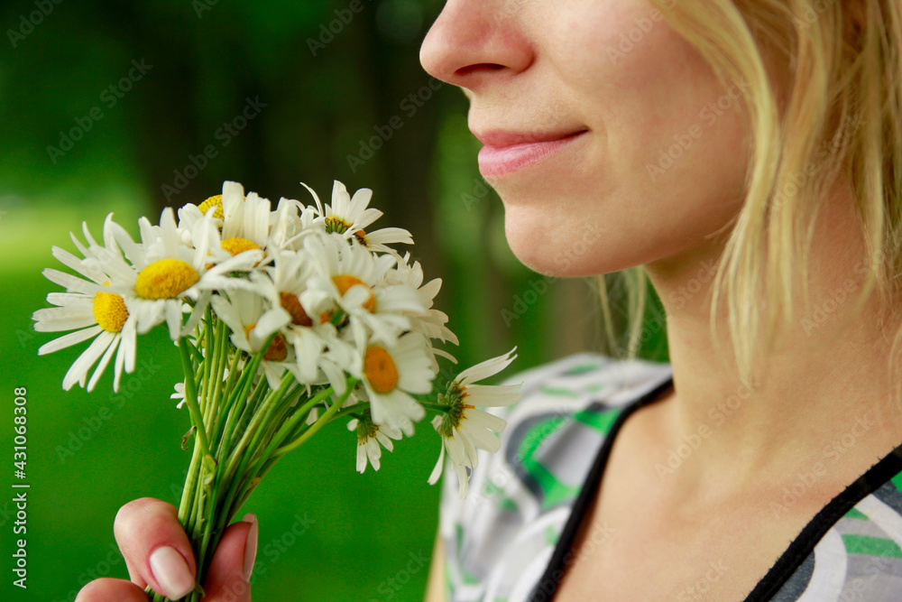 happy girl with a bouquet of flowers in the nature park happy girl with a bouquet of flowers in the nature park