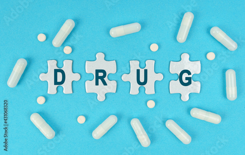 On a blue background, there are pills and puzzles with the inscription - DRUG