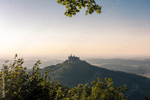 Aerial view of famous Hohenzollern Castle, ancestral seat of the imperial House of Hohenzollern and one of Europe's most visited castles, on the top of a green hill in Baden-Wurttemberg, Germany photo