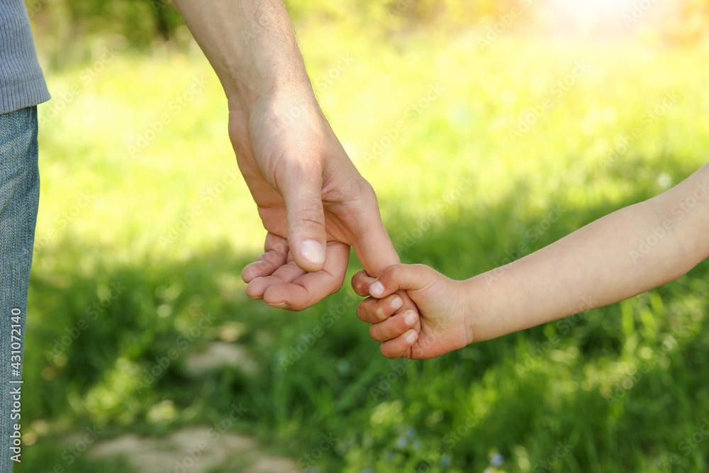 the parent holding the child's hand with a happy background the parent holding the child's hand with a happy background