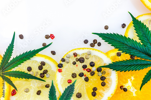 Cannabis Terpene concept with leafs lemons orange and peppercorns isolated on white