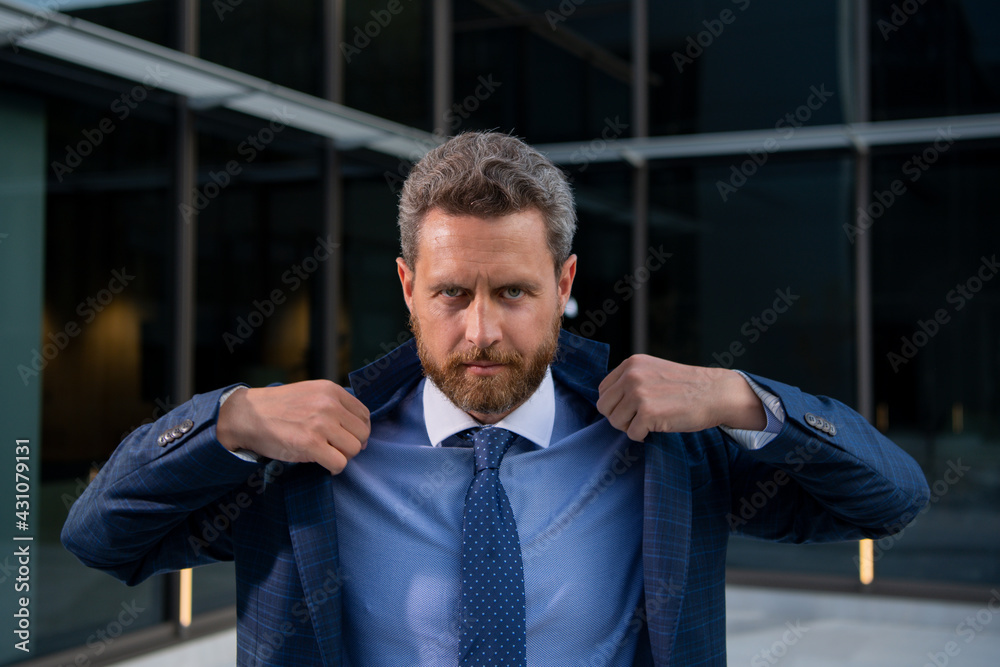 Fototapeta premium Businessman standing in city is happy to succeed in his work. Business man winner.