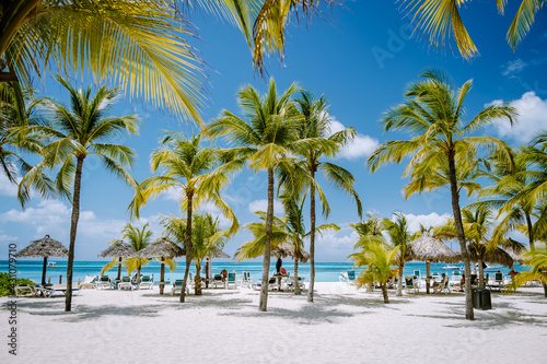 Palm Beach Aruba Caribbean, white long sandy beach with palm trees at Aruba Antilles photo