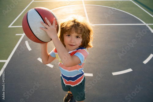 Child boy preparing for basketball shooting. Active lifestyle. Basketball kids school. © Volodymyr
