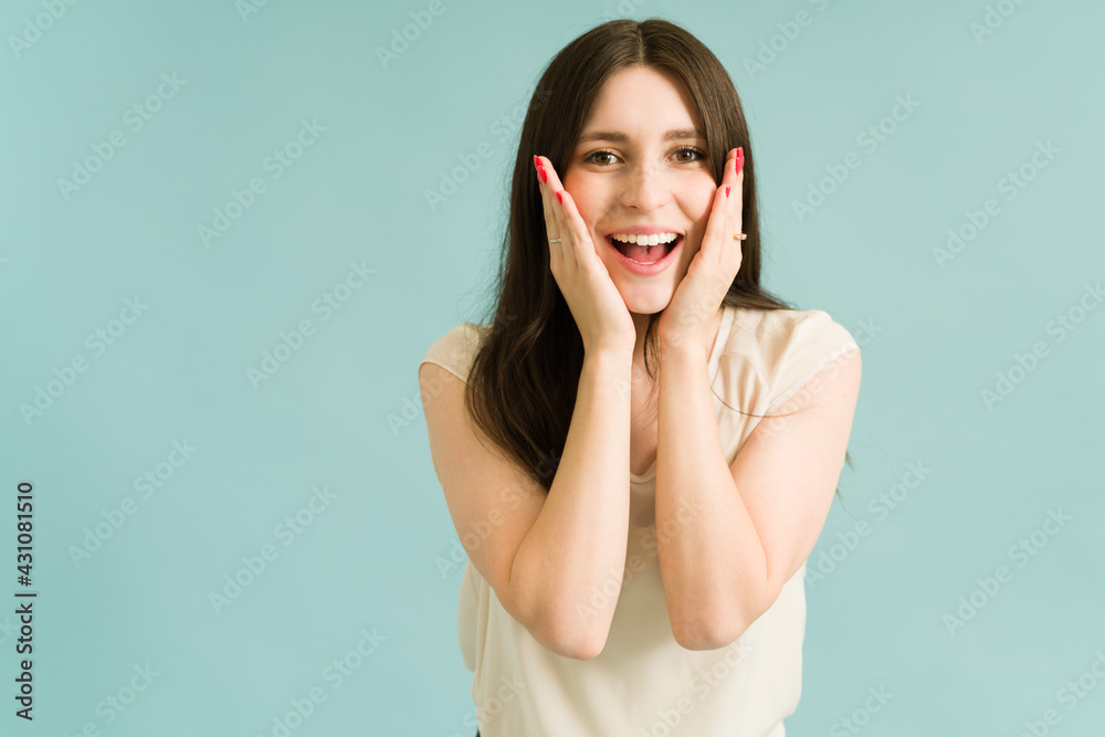 Young woman with the hands on the side of her face Young woman with the hands on the side of her face