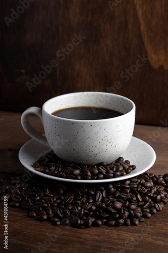 Coffe cup with milk and coffee grains