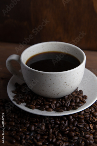 Coffe cup with milk and coffee grains